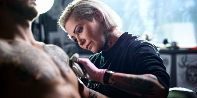 female-tattooist-applying-tattoo-to-male-customer-royalty-free-image-1605868156..jpeg